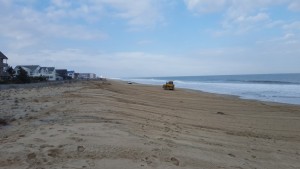 Bulldozer moving sand up the new sloped beach in Dewey Beach.